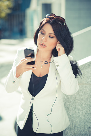 beautiful long black hair elegant business woman using smartphone  in the cityの写真素材