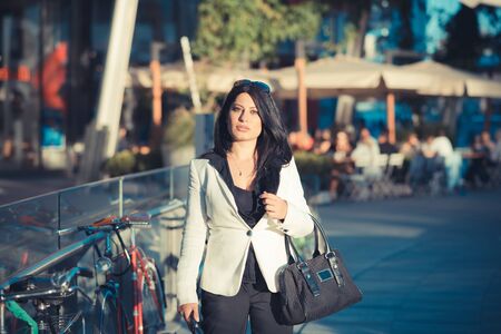 beautiful long black hair elegant business woman in the cityの写真素材