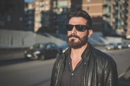 young handsome attractive bearded model man in urban contextの写真素材