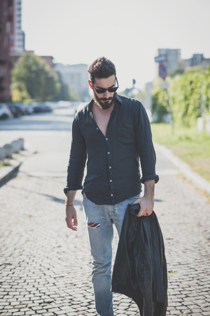 young handsome attractive bearded model man in urban contextの写真素材
