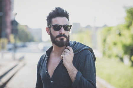 young handsome attractive bearded model man in urban contextの写真素材