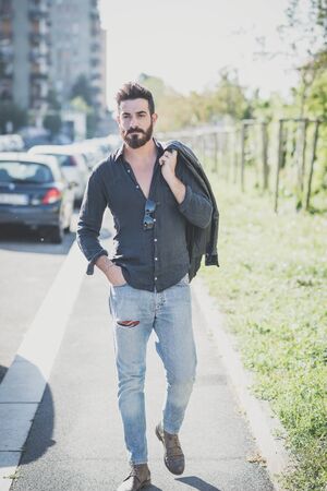 young handsome attractive bearded model man in urban contextの写真素材
