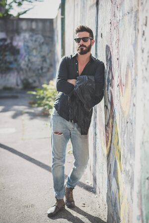 young handsome attractive bearded model man in urban contextの写真素材