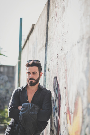 young handsome attractive bearded model man in urban contextの写真素材
