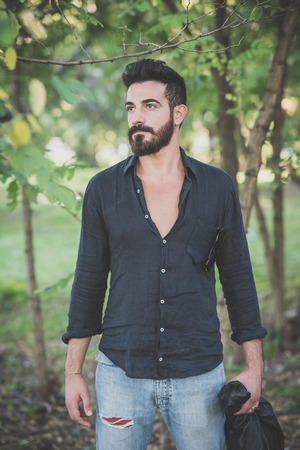young handsome attractive bearded model man in the woodsの写真素材