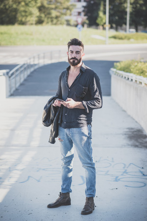 young handsome attractive bearded model man in urban contextの写真素材