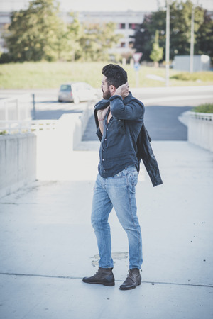 young handsome attractive bearded model man in urban contextの写真素材