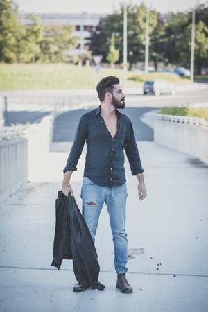 young handsome attractive bearded model man in urban contextの写真素材