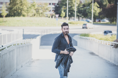 young handsome attractive bearded model man in urban contextの写真素材
