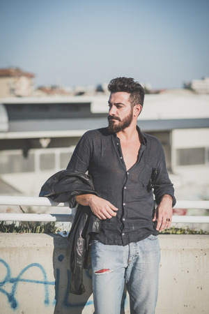 young handsome attractive bearded model man in urban contextの写真素材
