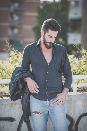 young handsome attractive bearded model man in urban contextの写真素材