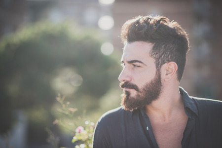 young handsome attractive bearded model man in urban contextの写真素材