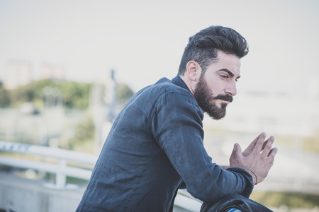 young handsome attractive bearded model man in urban contextの写真素材