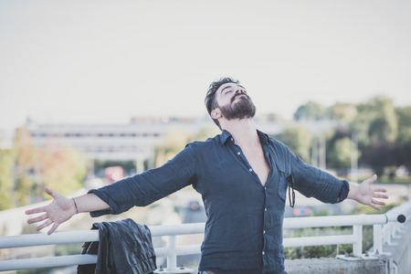 young handsome attractive bearded model man in urban contextの写真素材