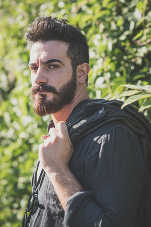 young handsome attractive bearded model man in urban contextの写真素材