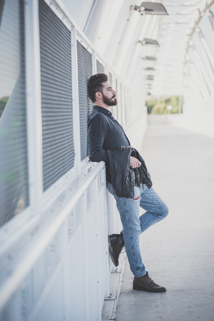 young handsome attractive bearded model man in urban contextの写真素材