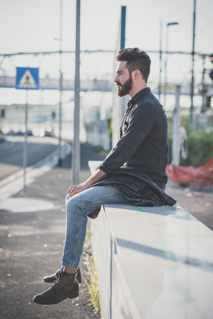 young handsome attractive bearded model man in urban contextの写真素材