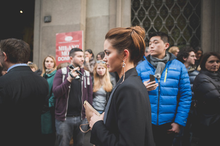 MILAN, ITALY - MARCH 01: People during Milan Fashion week, Italy on March, 01 2015. Eccentric and fashionable people outside city during Milan fashion week wait for models and famous peopleのeditorial素材