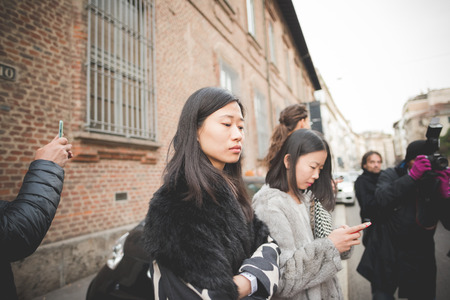 MILAN, ITALY - MARCH 01: People during Milan Fashion week, Italy on March, 01 2015. Eccentric and fashionable people outside city during Milan fashion week wait for models and famous peopleのeditorial素材