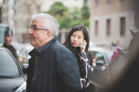 MILAN, ITALY - MARCH 01: People during Milan Fashion week, Italy on March, 01 2015. Eccentric and fashionable people outside city during Milan fashion week wait for models and famous peopleのeditorial素材