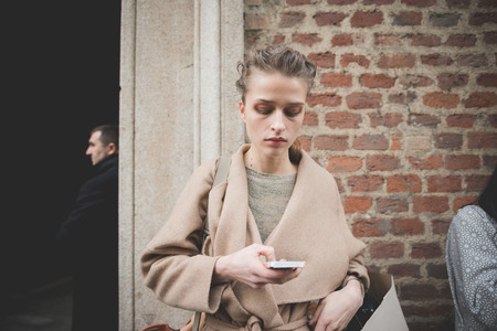 MILAN, ITALY - MARCH 01: People during Milan Fashion week, Italy on March, 01 2015. Eccentric and fashionable people outside city during Milan fashion week wait for models and famous peopleのeditorial素材
