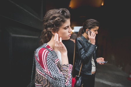 MILAN, ITALY - MARCH 01: People during Milan Fashion week, Italy on March, 01 2015. Eccentric and fashionable people outside city during Milan fashion week wait for models and famous peopleのeditorial素材