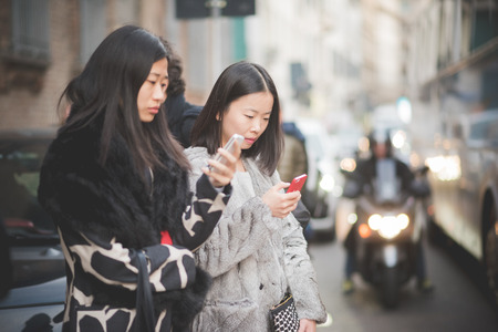 MILAN, ITALY - MARCH 01: People during Milan Fashion week, Italy on March, 01 2015. Eccentric and fashionable people outside city during Milan fashion week wait for models and famous peopleのeditorial素材