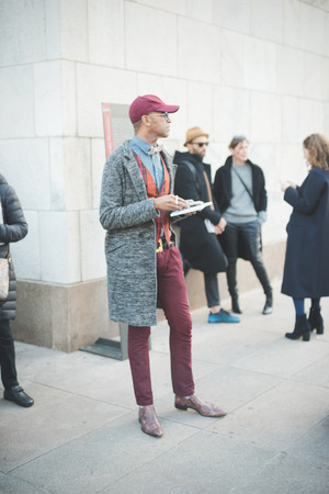 MILAN, ITALY - FEBRUARY 28: People during Milan Fashion week, Italy on February, 28 2015. Eccentric and fashionable people outside city during Milan fashion week wait for models and famous peopleのeditorial素材