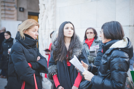 MILAN, ITALY - FEBRUARY 28: People during Milan Fashion week, Italy on February, 28 2015. Eccentric and fashionable people outside city during Milan fashion week wait for models and famous peopleのeditorial素材