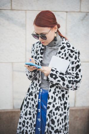 MILAN, ITALY - FEBRUARY 28: People during Milan Fashion week, Italy on February, 28 2015. Eccentric and fashionable people outside city during Milan fashion week wait for models and famous peopleのeditorial素材