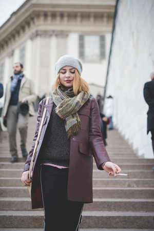 MILAN, ITALY - FEBRUARY 28: People during Milan Fashion week, Italy on February, 28 2015. Eccentric and fashionable people outside city during Milan fashion week wait for models and famous peopleのeditorial素材