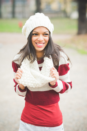 young beautiful indian woman at the park in autumnの写真素材