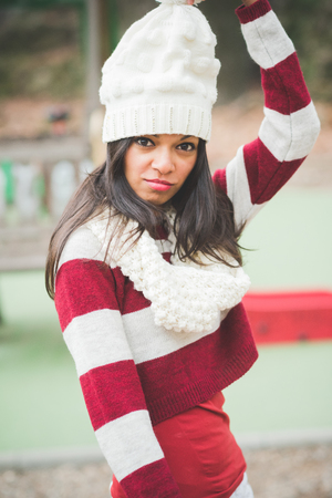 young beautiful indian woman at the park in autumnの写真素材