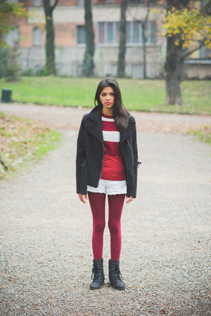 young beautiful indian woman at the park in autumnの写真素材