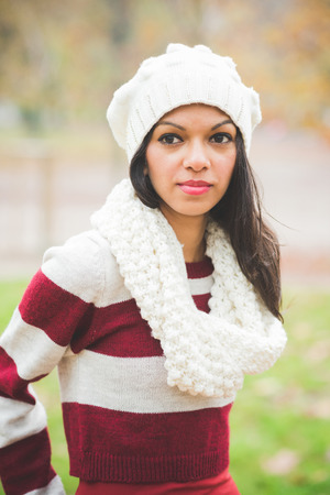 young beautiful indian woman at the park in autumnの写真素材