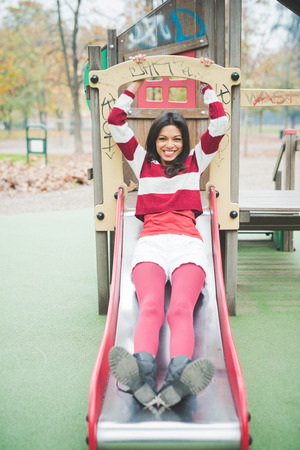 young beautiful indian woman at the park in autumnの写真素材