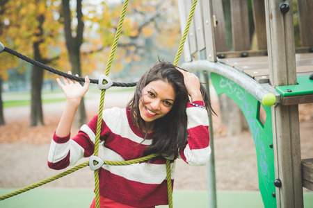 young beautiful indian woman at the park in autumnの写真素材