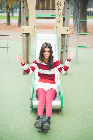 young beautiful indian woman at the park in autumnの写真素材