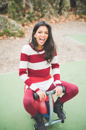 young beautiful indian woman at the park in autumnの写真素材