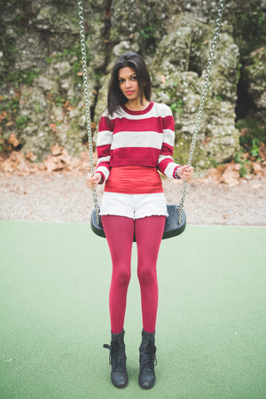 young beautiful indian woman at the park in autumnの写真素材
