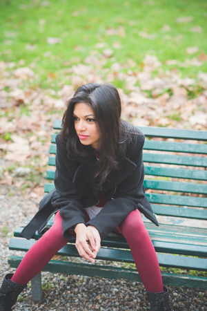 young beautiful indian woman at the park in autumnの写真素材