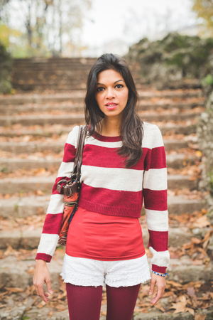 young beautiful indian woman at the park in autumnの写真素材