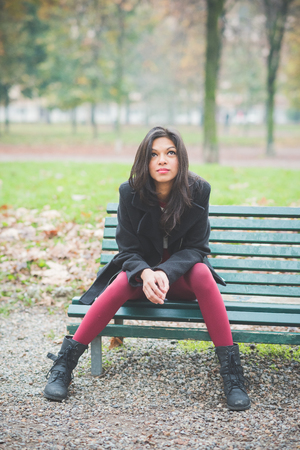 young beautiful indian woman at the park in autumnの写真素材