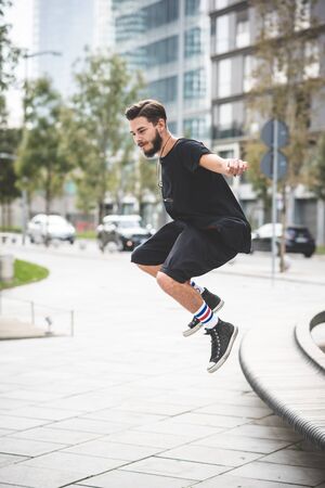 young handsome bearded hipster man in the cityの写真素材