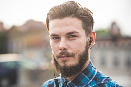 young handsome bearded hipster man in the cityの写真素材