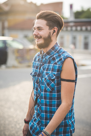 young handsome bearded hipster man in the cityの写真素材