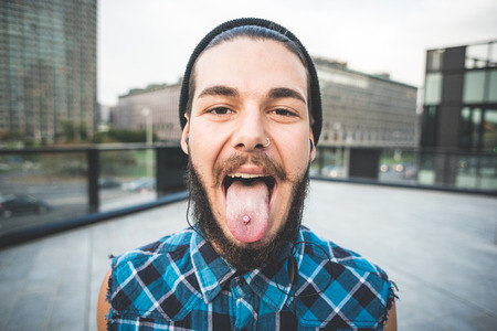 young handsome bearded hipster man in the cityの写真素材
