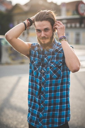 young handsome bearded hipster man in the cityの写真素材