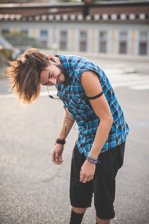 young handsome bearded hipster man in the cityの写真素材