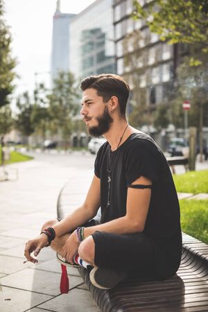 young handsome bearded hipster man in the cityの写真素材